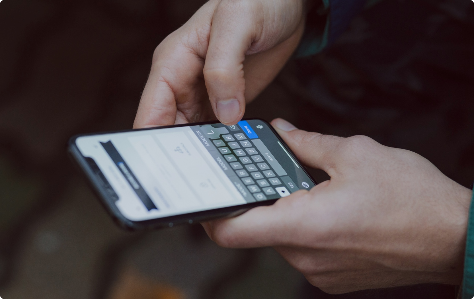 A person is holding a mobile phone and using the Ticket App from 1Tool.